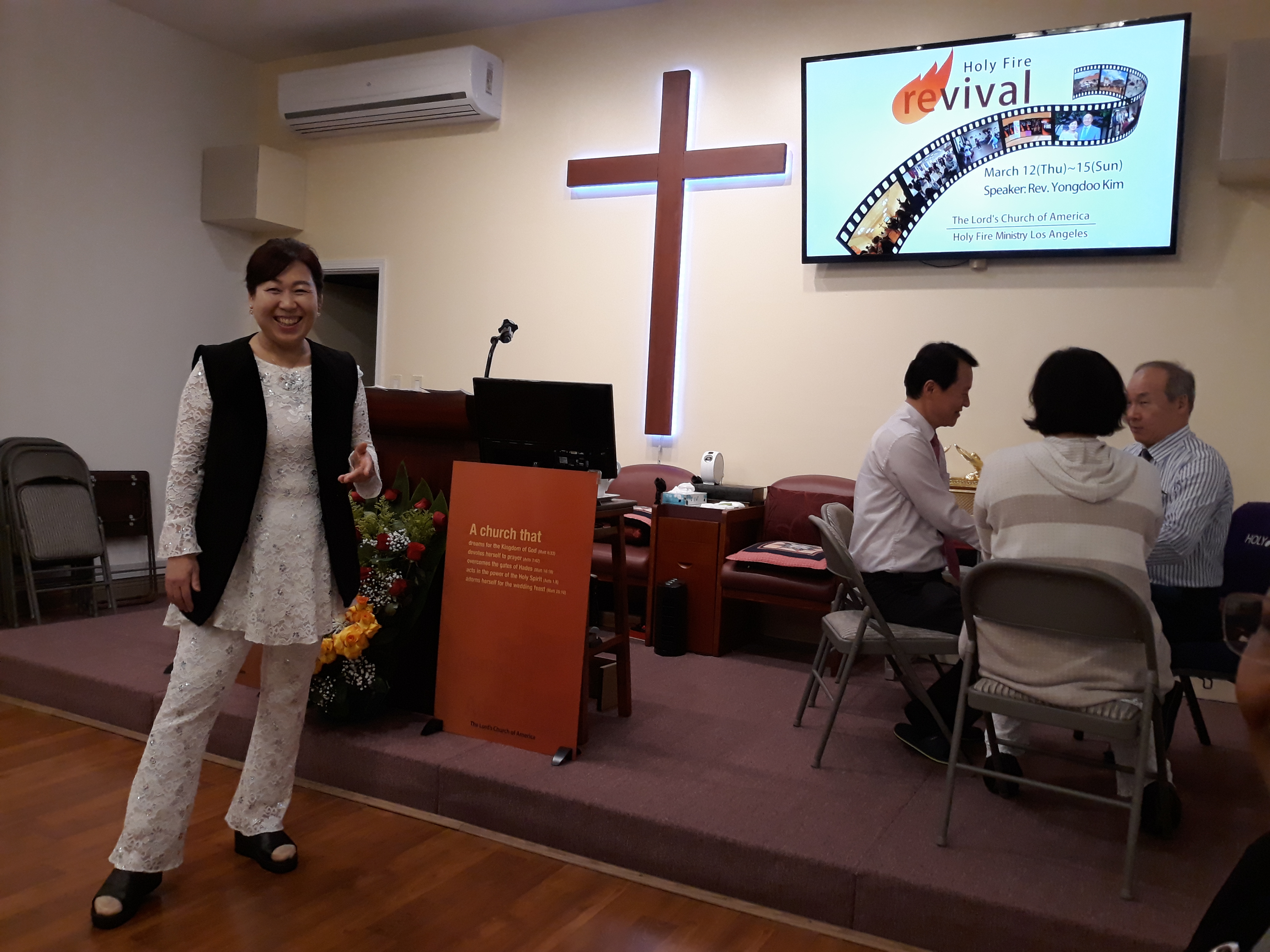 Pastor Kim's wife is seen here during a Holy Fire Revival (on the left). Pastor Kim is working with Pastor Cho & Mrs. Cho (on the right).
